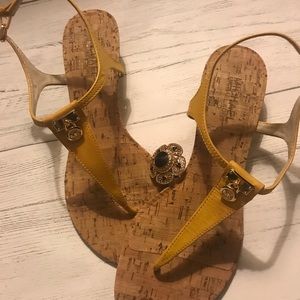 Yellow sandals with a wedge.